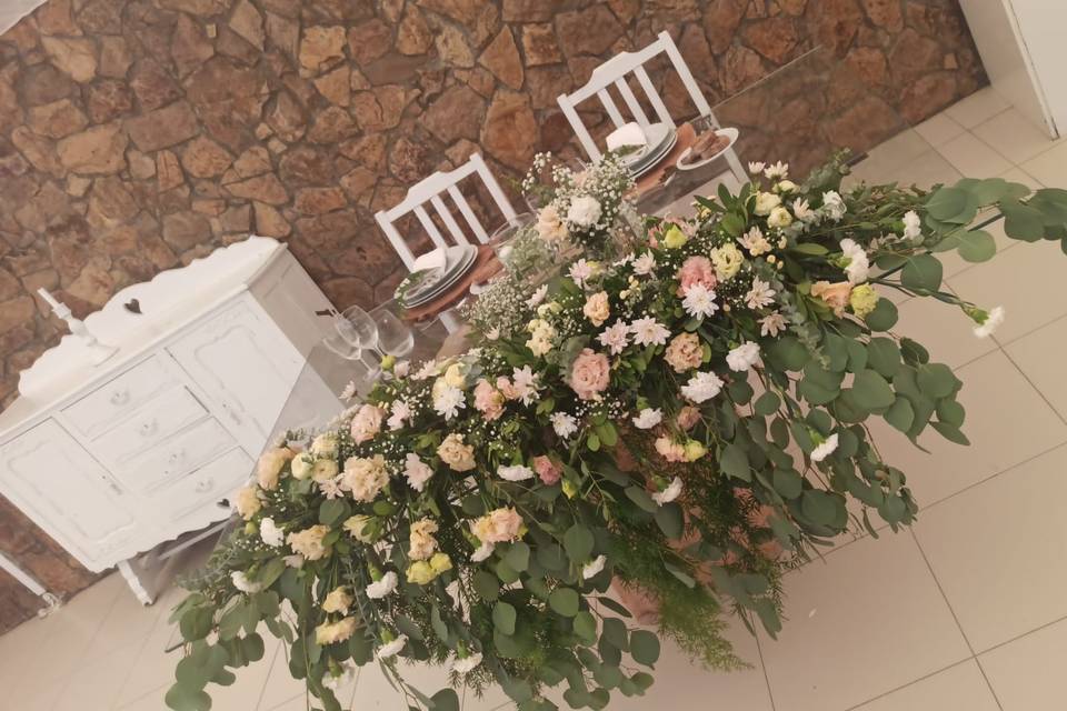 Mesa dos noivos com flores